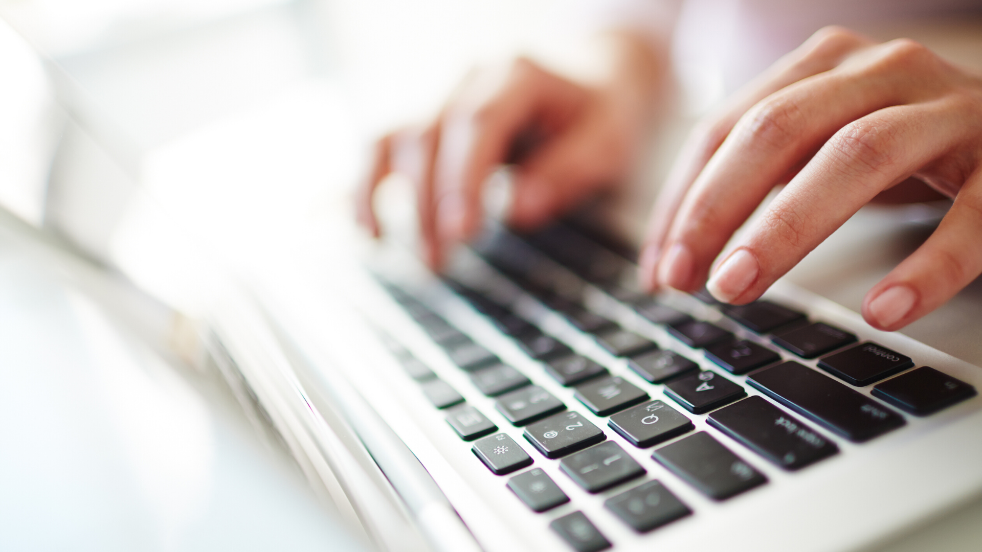 hands on laptop keyboard