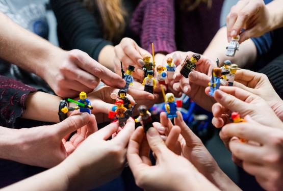Hands holding Lego figures 