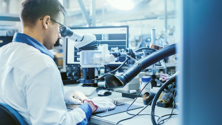 man in lab at desk