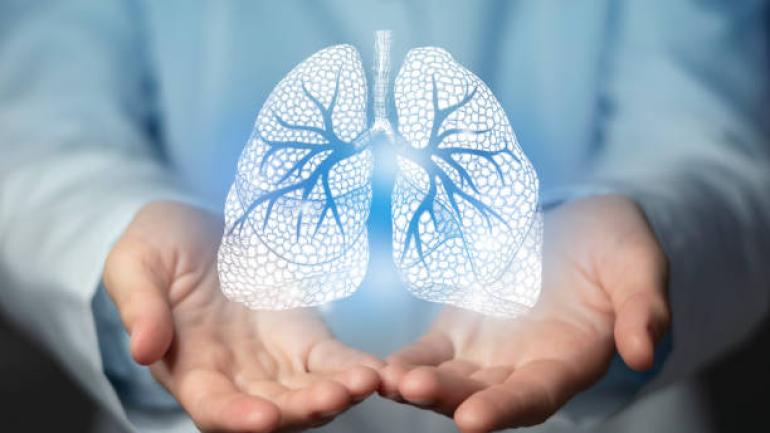 Picture of lungs above a person's hands